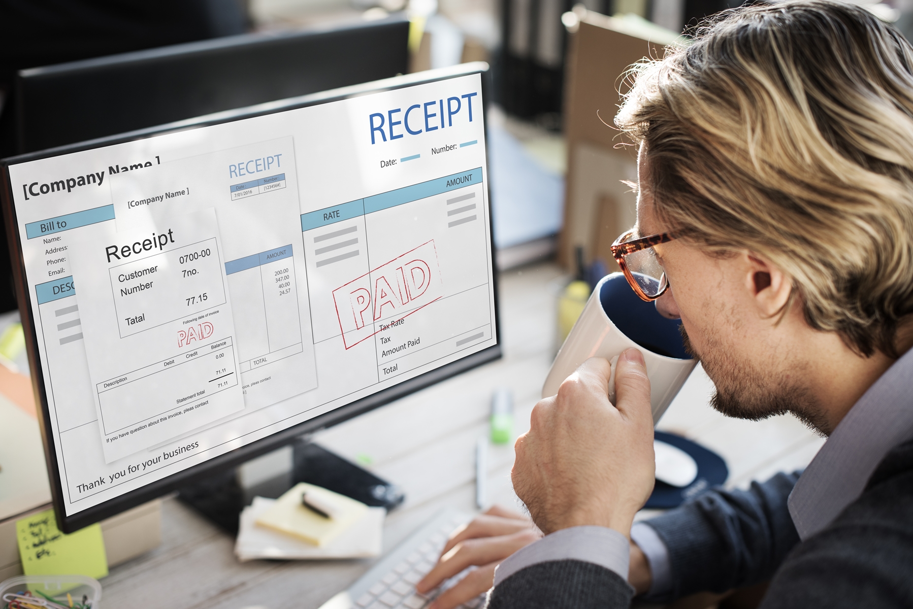 A woman looking at her laptop after a receipt of processed transfer