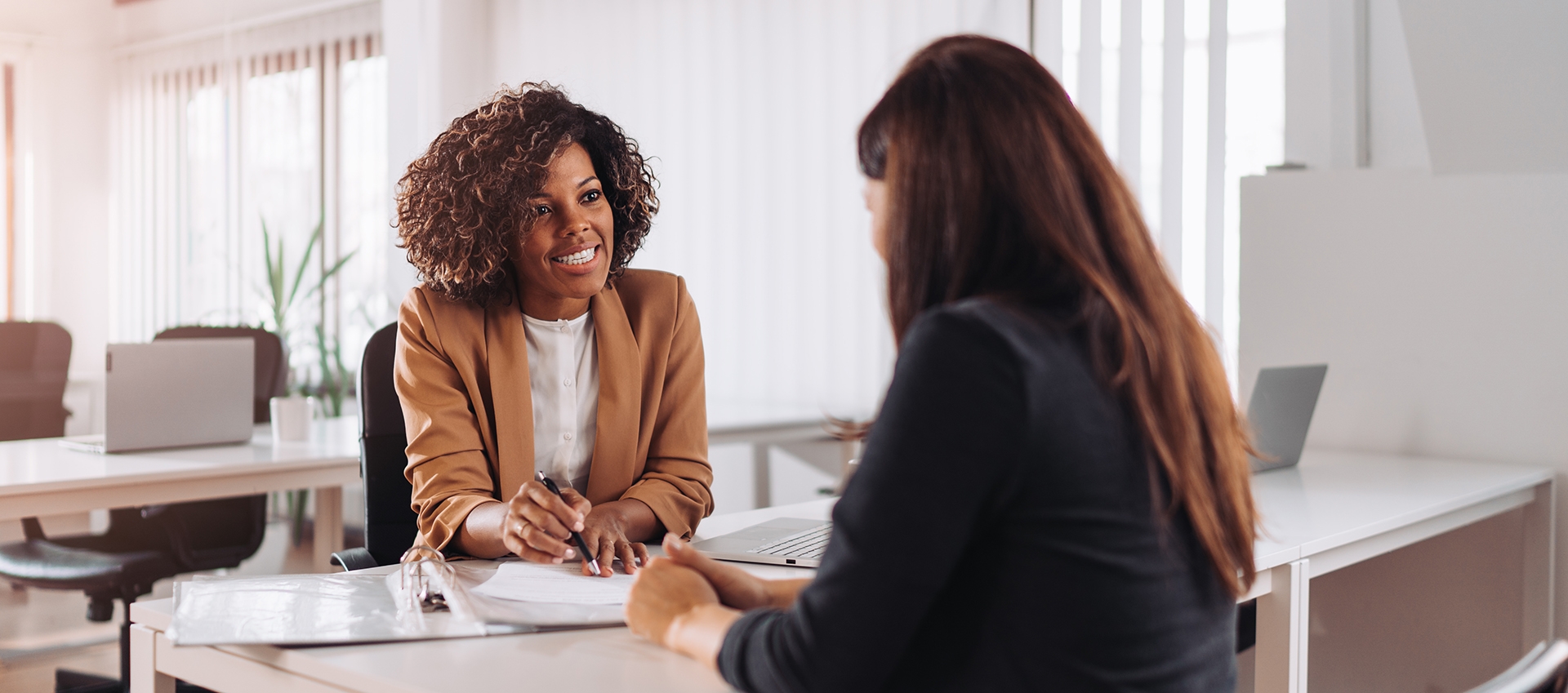 Two woman in a banking conversing