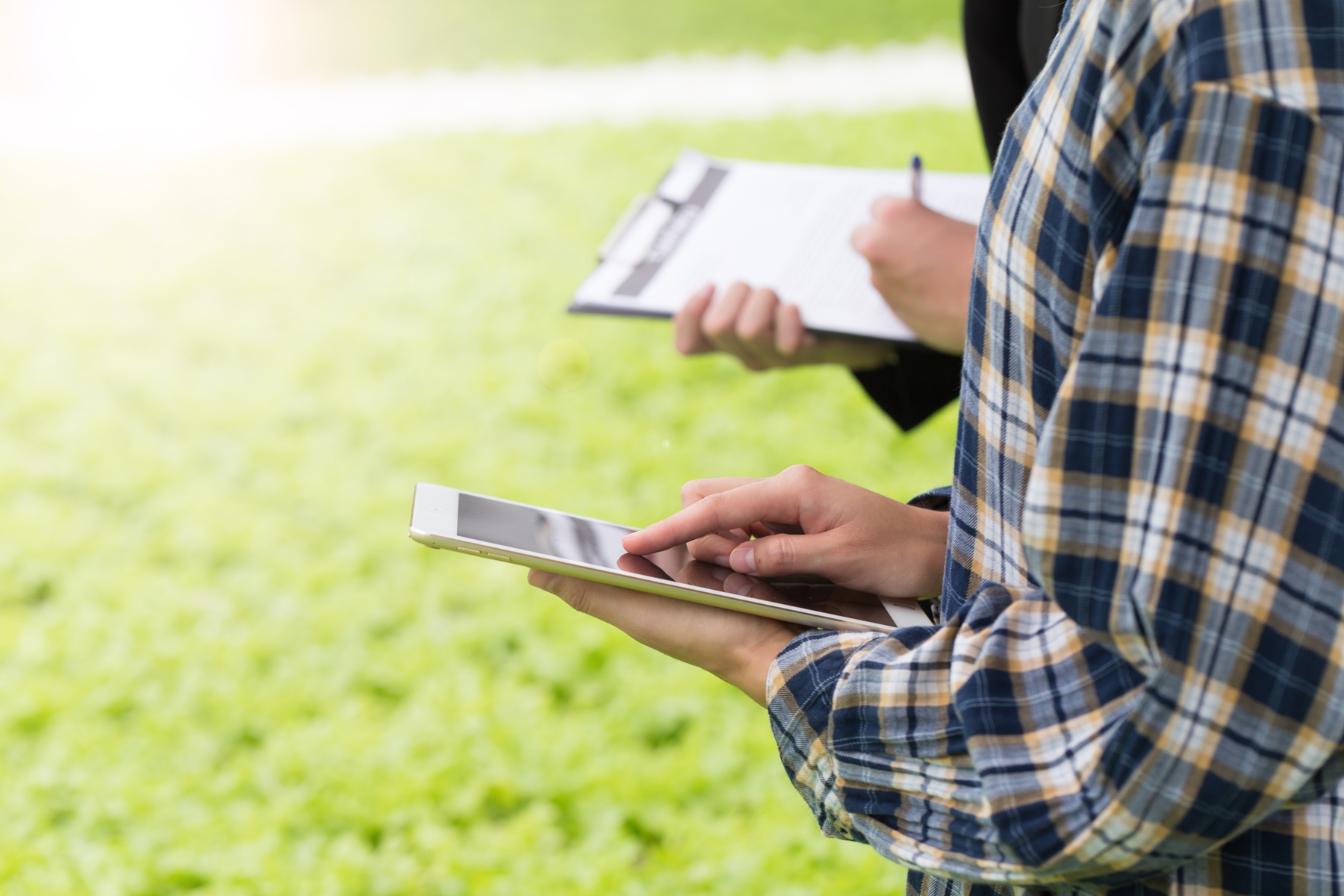 Two men checking a an order on their phone and tablet